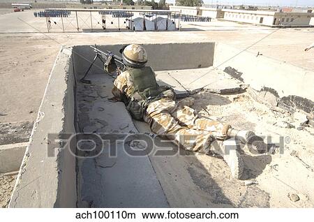 A British soldier provides security from a rooftop in Basra, Iraq. View Large Photo Image Picture - A British soldier provides security from a rooftop in Basra, Iraq.. Fotosearch