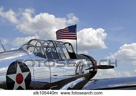 A BT-13 Valiant trainer aircraft with American Flag. View Large Photo Image Picture - A BT-13 Valiant trainer aircraft with American Flag.. Fotosearch