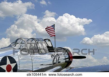 A BT-13 Valiant trainer aircraft with American Flag. View Large Photo Image Picture - A BT-13 Valiant trainer aircraft with American Flag.. Fotosearch