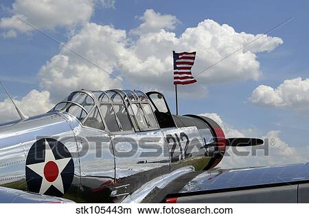 A BT-13 Valiant trainer aircraft with American Flag. View Large Photo Image Picture - A BT-13 Valiant trainer aircraft with American Flag.. Fotosearch