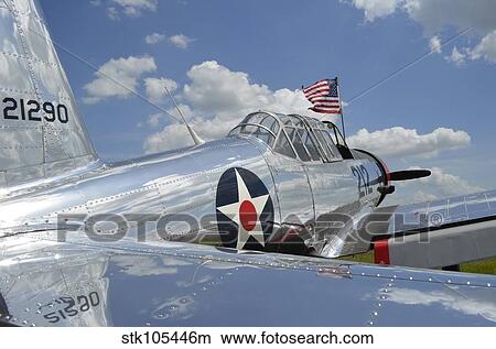 A BT-13 Valiant trainer aircraft with American Flag. View Large Photo Image Picture - A BT-13 Valiant trainer aircraft with American Flag.. Fotosearch