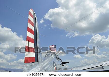A BT-13 Valiant trainer aircraft with American Flag. View Large Photo Image Picture - A BT-13 Valiant trainer aircraft with American Flag.. Fotosearch