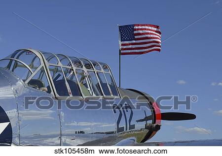 Picture - A BT-13 Valiant trainer aircraft with American Flag.. Fotosearch