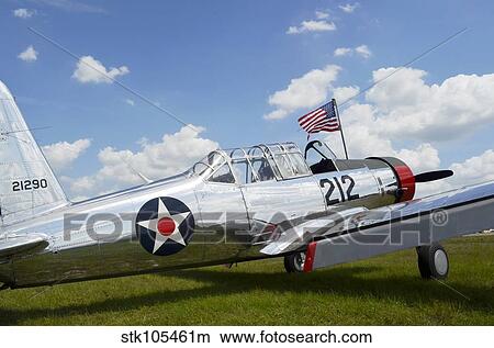 A BT-13 Valiant trainer aircraft with American Flag. View Large Photo Image Picture - A BT-13 Valiant trainer aircraft with American Flag.. Fotosearch