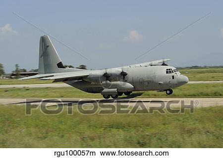A C-130 Hercules of the Italian Air Force performs a touch and go landing. View Large Photo Image Picture - A C-130 Hercules of the Italian Air Force performs a touch and go landing.. Fotosearch