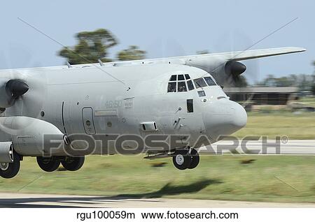 A C-130 Hercules of the Italian Air Force performs a touch and go landing. View Large Photo Image Picture - A C-130 Hercules of the Italian Air Force performs a touch and go landing.. Fotosearch