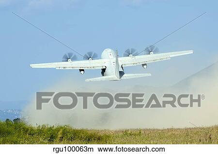 A C-130 Hercules of the Italian Air Force taking off. View Large Photo Image Picture - A C-130 Hercules of the Italian Air Force taking off.. Fotosearch