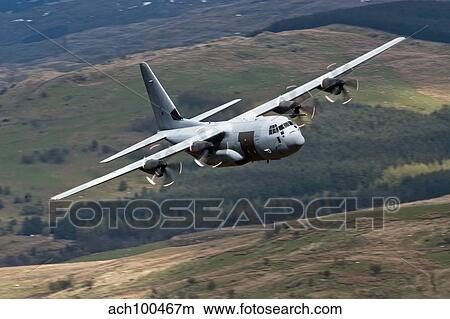A C-130 Hercules of the Royal Air Force flying over North Wales. View Large Photo Image Picture - A C-130 Hercules of the Royal Air Force flying over North Wales.. Fotosearch