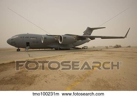 A C-17 Globemaster III sits on the runway at COB Speicher, Iraq. View Large Photo Image Picture - A C-17 Globemaster III sits on the runway at COB Speicher, Iraq.. Fotosearch