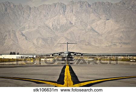 A C-17 Globemaster III taxis to its parking spot at Bagram Airfield. View Large Photo Image Picture - A C-17 Globemaster III taxis to its parking spot at Bagram Airfield.. Fotosearch