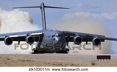 A C-17 Globemaster lands on the runway. View Large Photo Image Picture - A C-17 Globemaster lands on the runway.. Fotosearch