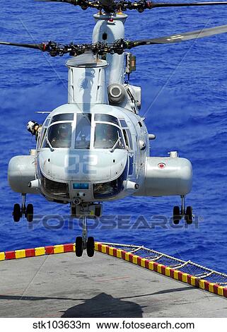 A CH-46E Sea Knight helicopter prepares to land on the flight deck of USS Peleliu. View Large Photo Image Picture - A CH-46E Sea Knight helicopter prepares to land on the flight deck of USS Peleliu.. Fotosearch