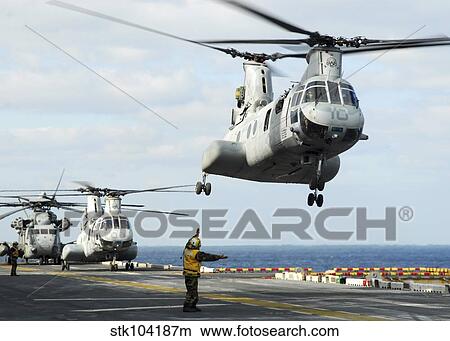 A CH-46E Sea Knight helicopter takes off from the flight deck of USS Essex. View Large Photo Image Picture - A CH-46E Sea Knight helicopter takes off from the flight deck of USS Essex.. Fotosearch