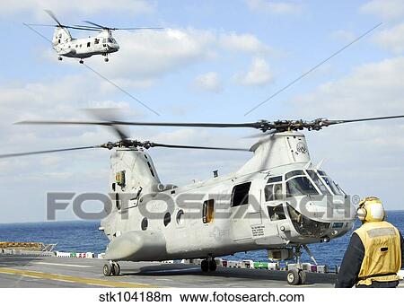 A CH-46E Sea Knight helicopter takes off from the flight deck of USS Essex. View Large Photo Image Picture - A CH-46E Sea Knight helicopter takes off from the flight deck of USS Essex.. Fotosearch