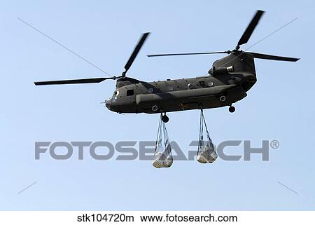 A CH-47 Chinook carrying sandbags. View Large Photo Image Picture - A CH-47 Chinook carrying sandbags.. Fotosearch