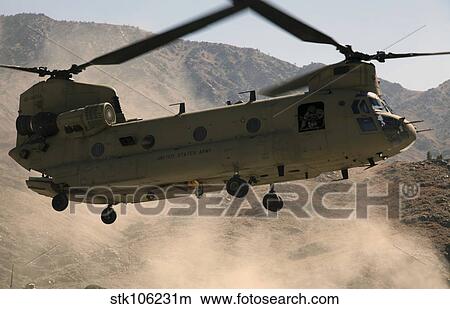 A CH-47 Chinook helicopter kicks up dust as it lands in Afghanistan. View Large Photo Image Picture - A CH-47 Chinook helicopter kicks up dust as it lands in Afghanistan.. Fotosearch