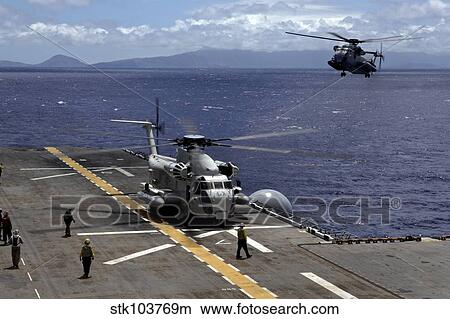 A CH-53D Sea Stallion sits on the flight deck as another prepares to land aboard USS Bonhomme Richard. View Large Photo Image Picture - A CH-53D Sea Stallion sits on the flight deck as another prepares to land aboard USS Bonhomme Richard.. Fotosearch