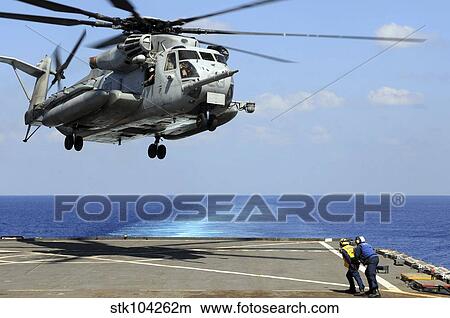 A CH-53E Super Stallion lifts off from an amphibious dock landing ship. View Large Photo Image Picture - A CH-53E Super Stallion lifts off from an amphibious dock landing ship.. Fotosearch
