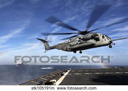 A CH-53E Super Stallion prepares to land on USNS Arctic. View Large Photo Image Picture - A CH-53E Super Stallion prepares to land on USNS Arctic.. Fotosearch