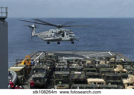 A CH-53E Super Stallion prepares to land on the flight deck of USS Ashland. View Large Photo Image Picture - A CH-53E Super Stallion prepares to land on the flight deck of USS Ashland.. Fotosearch