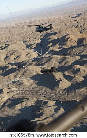 A CH-53E Super Stallion transports a CH-47 Chinook over Afghanistan. View Large Photo Image Picture - A CH-53E Super Stallion transports a CH-47 Chinook over Afghanistan.. Fotosearch