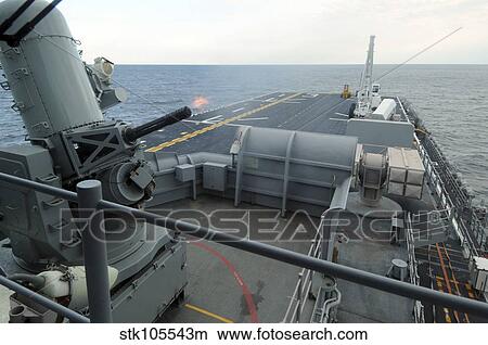 A close-in weapons system fires aboard USS Kearsarge. View Large Photo Image Picture - A close-in weapons system fires aboard USS Kearsarge.. Fotosearch