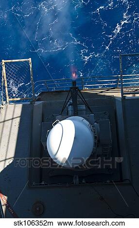 A closed-in weapons system fires from the fantail aboard USS John C. Stennis. View Large Photo Image Picture - A closed-in weapons system fires from the fantail aboard USS John C. Stennis.. Fotosearch