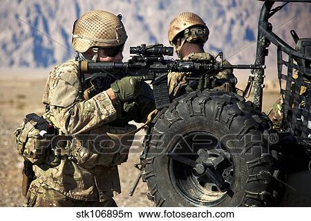 A coalition force member maintains security in an Afghan village. View Large Photo Image Picture - A coalition force member maintains security in an Afghan village.. Fotosearch