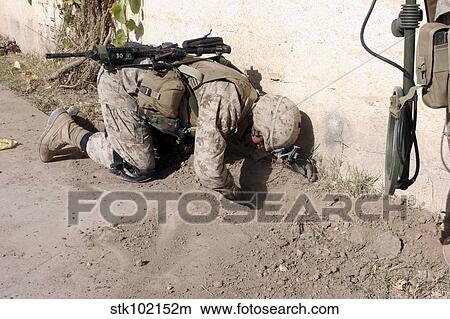 A combat engineer searches for weapons caches. View Large Photo Image Picture - A combat engineer searches for weapons caches.. Fotosearch