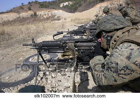 Picture - A corpsman fires an M249 Squad Automatic Weapon.. Fotosearch