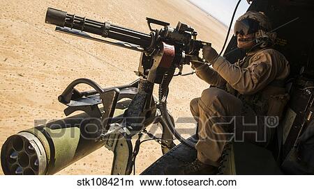 Picture - A crew chief mounts a M134 Minigun.. Fotosearch