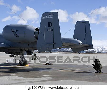 A crew chief performs preflight inspections on an A-10 Thunderbolt. View Large Photo Image Picture - A crew chief performs preflight inspections on an A-10 Thunderbolt.. Fotosearch