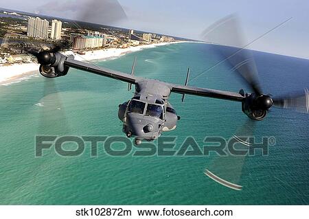 A CV-22 Osprey aircraft flies over Florida's Emerald Coast. View Large Photo Image Picture - A CV-22 Osprey aircraft flies over Florida's Emerald Coast.. Fotosearch