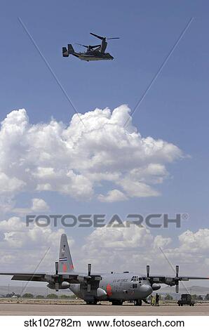 Picture - A CV-22 Osprey flies over a C-130 Hercules.. Fotosearch