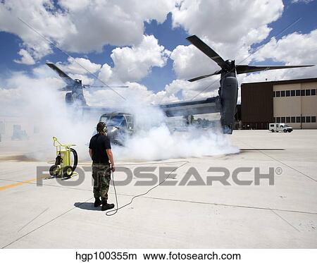 A CV-22 Osprey starts its engines at Kirtland Air Force Base. View Large Photo Image Picture - A CV-22 Osprey starts its engines at Kirtland Air Force Base.. Fotosearch