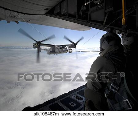 A CV-22B Osprey receives fuel off the coast of Greenland. View Large Photo Image Picture - A CV-22B Osprey receives fuel off the coast of Greenland.. Fotosearch