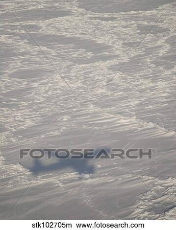 A DC-8 aircraft casts its shadow over the Bering Sea. View Large Photo Image Picture - A DC-8 aircraft casts its shadow over the Bering Sea.. Fotosearch