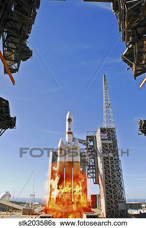 Stock Photograph - A Delta IV Heavy Launch Vehicle launches from Vandenberg Air Force Base.. Fotosearch