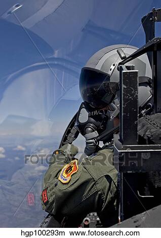 A F-15 pilot looks over at his wingman while in flight. View Large Photo Image Picture - A F-15 pilot looks over at his wingman while in flight.. Fotosearch
