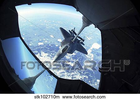 A F-22 Raptor refuels behind a KC-10 Extender. View Large Photo Image Picture - A F-22 Raptor refuels behind a KC-10 Extender.. Fotosearch