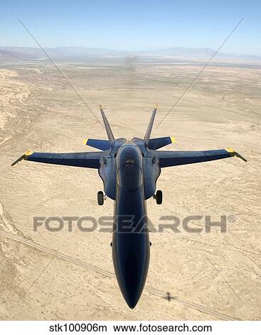 A F/A-18A Hornet flys over the desert landscape of Imperial Valley. View Large Photo Image Picture - A F/A-18A Hornet flys over the desert landscape of Imperial Valley.. Fotosearch