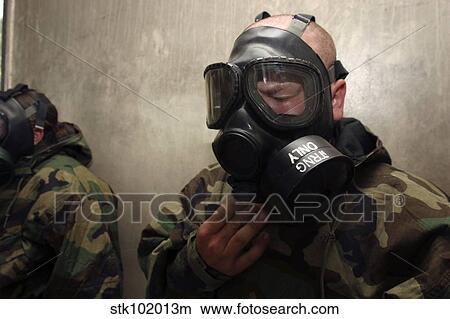 A field radio operator clears CS gas from his gas mask at the gas chamber. View Large Photo Image Picture - A field radio operator clears CS gas from his gas mask at the gas chamber.. Fotosearch