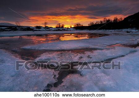 A fiery sunrise over Lavangsfjord, Troms, Norway. View Large Photo Image Stock Photograph - A fiery sunrise over Lavangsfjord, Troms, Norway.. Fotosearch