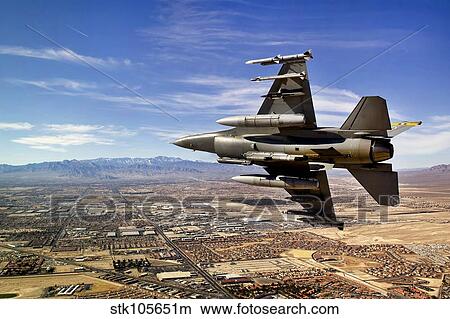 A fighter jet breaks right on a final approach over northern Las Vegas, Nevada. View Large Photo Image Picture - A fighter jet breaks right on a final approach over northern Las Vegas, Nevada.. Fotosearch