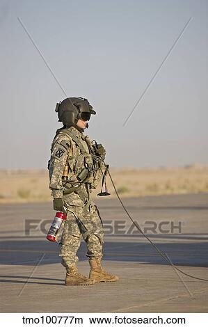 A flight crew member stands by with a fire extinguisher. View Large Photo Image Picture - A flight crew member stands by with a fire extinguisher.. Fotosearch