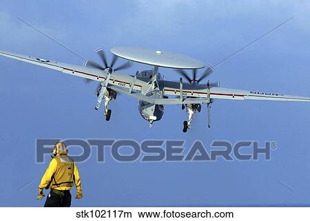 A flight deck director watches an E-2C Hawkeye taking off. View Large Photo Image Picture - A flight deck director watches an E-2C Hawkeye taking off.. Fotosearch