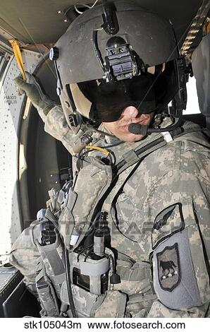 Picture - A flight medic conducts a daily pre-flight inspection at Al Asad Air Base, Iraq.. Fotosearch