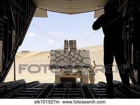 A forklift loads cargo onto a C-130 Hercules. View Large Photo Image Picture - A forklift loads cargo onto a C-130 Hercules.. Fotosearch