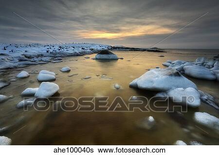 Stock Photograph - A frozen, rusty bay on Andoya Island in Nordland County, Norway.. Fotosearch