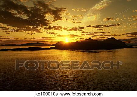 Stock Illustration - A gas giant and multiple moons look down on a beautiful island sunset. Fotosearch